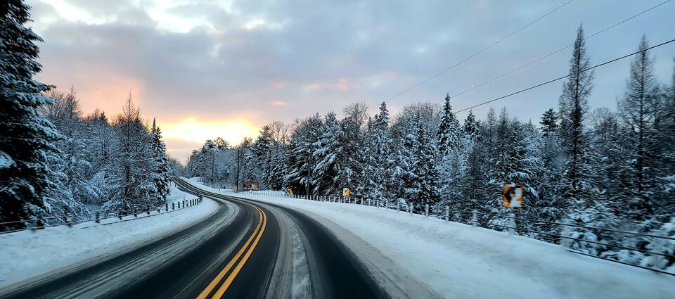 An icy road leads into the distance